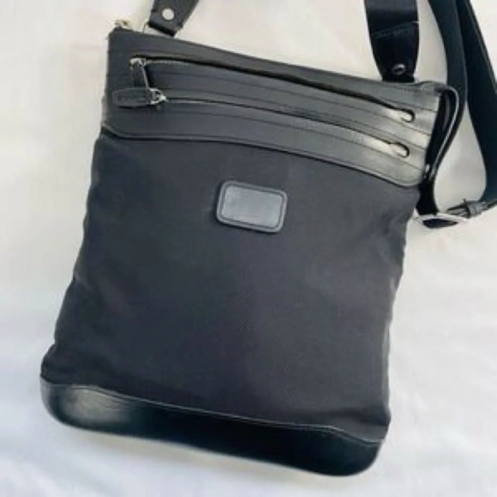 Tumi Black Messenger Bag with Silver Accents. Excellent condition